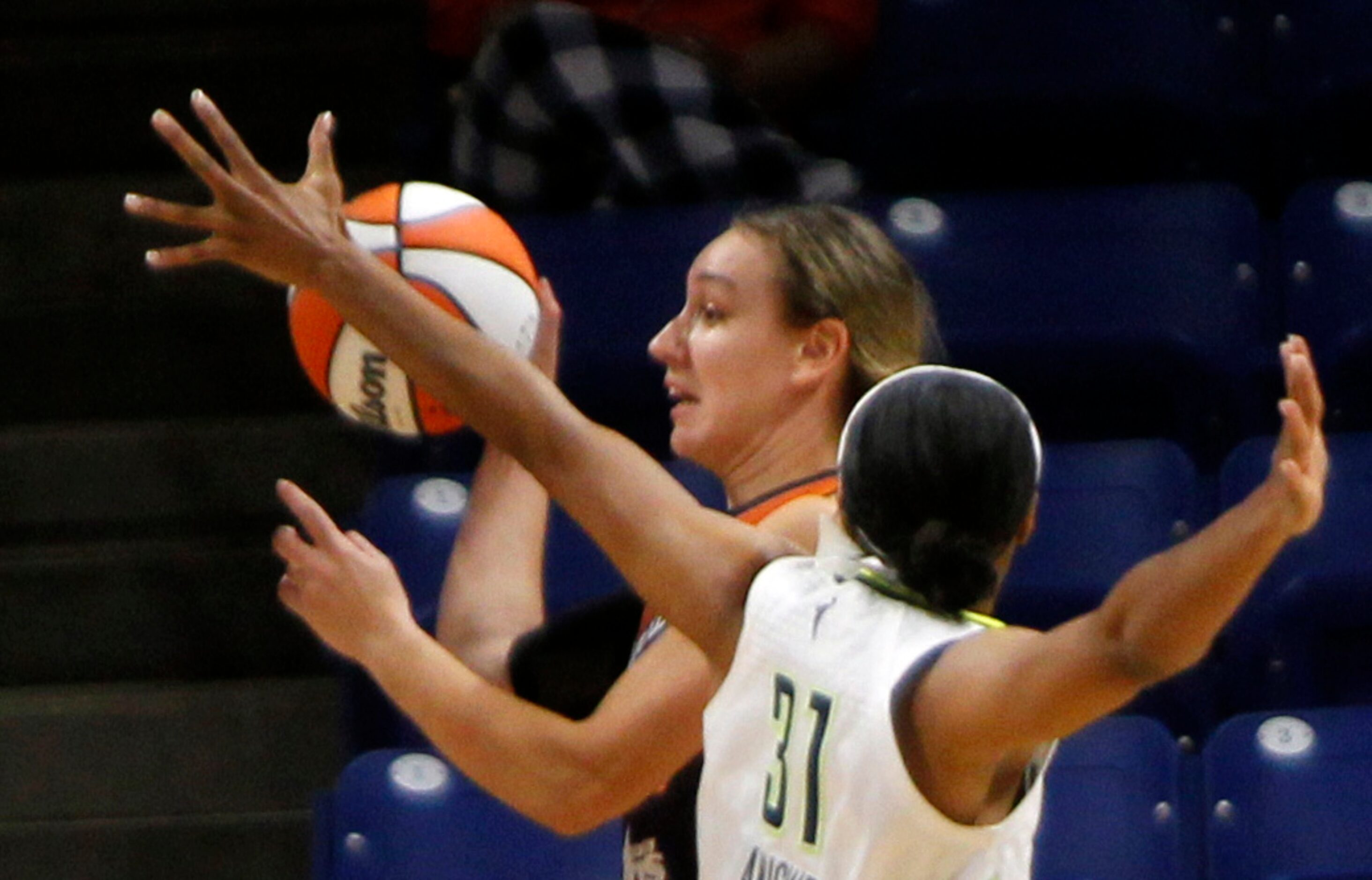 Phoenix forward Alanna Smith (11) attempts a pass along the baseline as she is defended by...