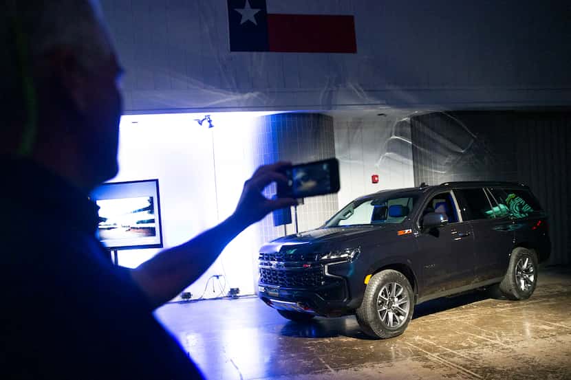 Attendees photograph the new Chevrolet Tahoe during the unveiling event of the...