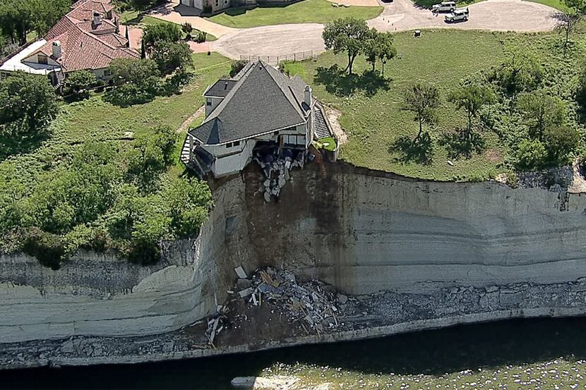 A luxury home build on a cliff overlooking Lake Whitney has partially collapsed into the...
