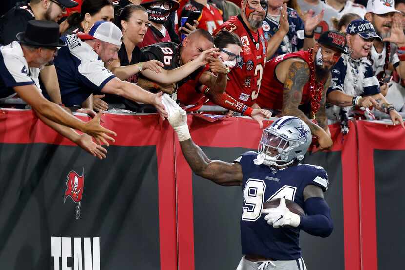Dallas Cowboys defensive end Randy Gregory (94) receives high-fives from fans after his...