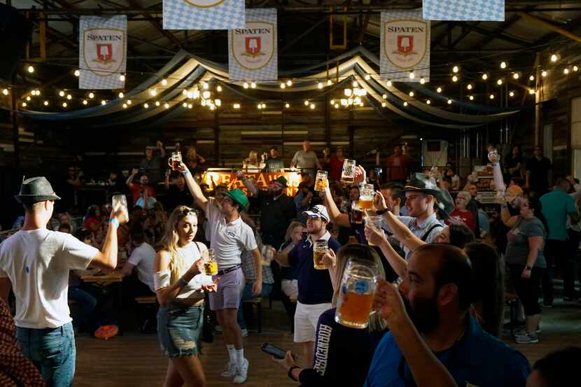 People toast during the "Ein Prosit" sing-a-long at the 2018 Octoberfest at Panther Island...