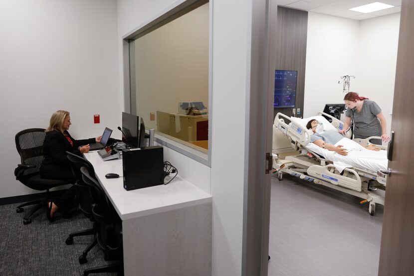 Regional Simulation Lab executive director Karen Meadows, left, regulates a mannequin named...