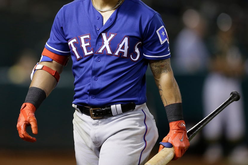 Texas Rangers' Rougned Odor walks off the field after striking out against Oakland...
