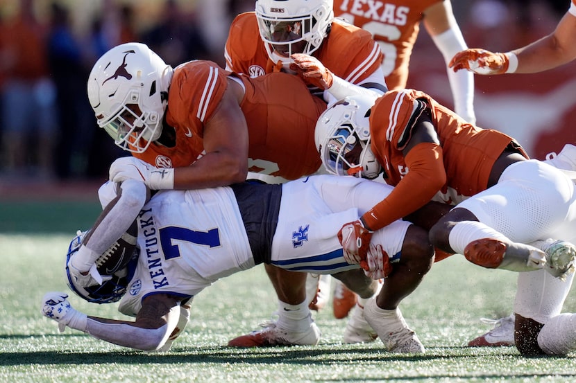 Kentucky wide receiver Barion Brown (7) is stopped by Texas defensive back Andrew Mukuba,...