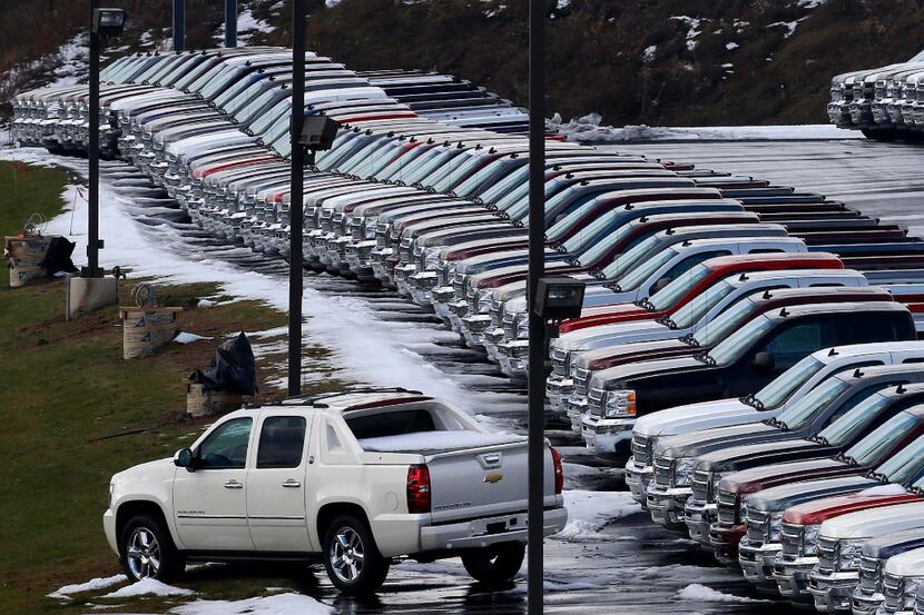 In this Wednesday, Jan. 9, 2013, file photo, Chevy trucks line the lot of a dealer in...