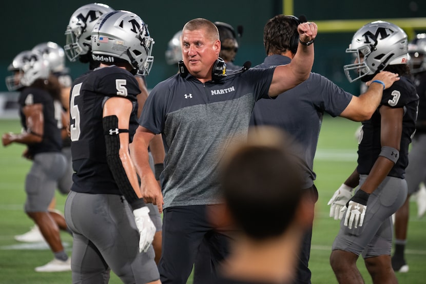 Arlington Martin head coach Bob Wager talks to his son senior Gage Wager (5) during a...