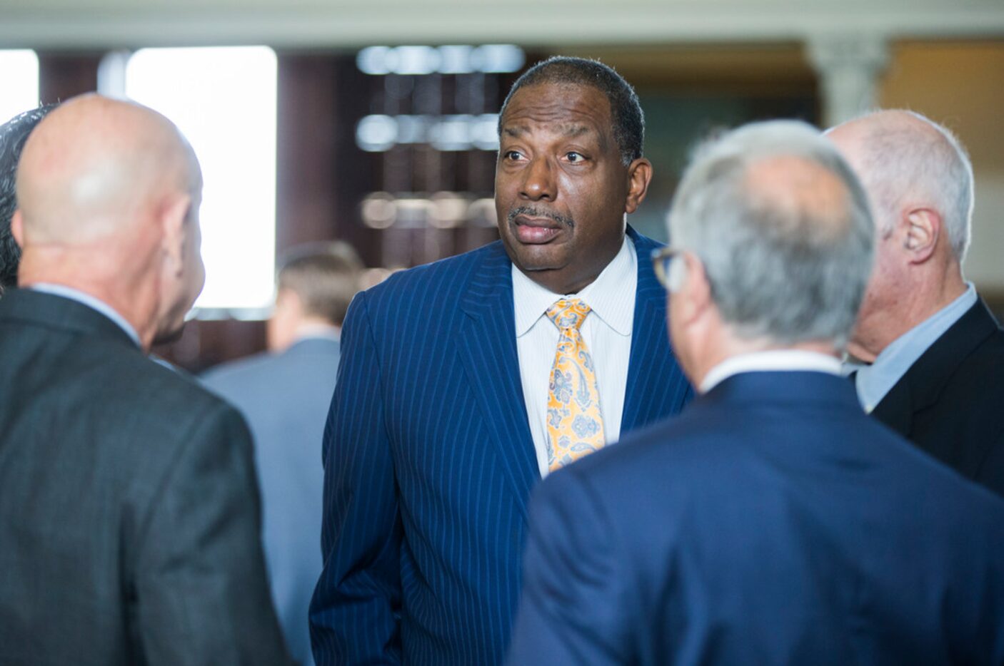 Senator Royce West, center, talks with other senators on the second day of the 86th Texas...