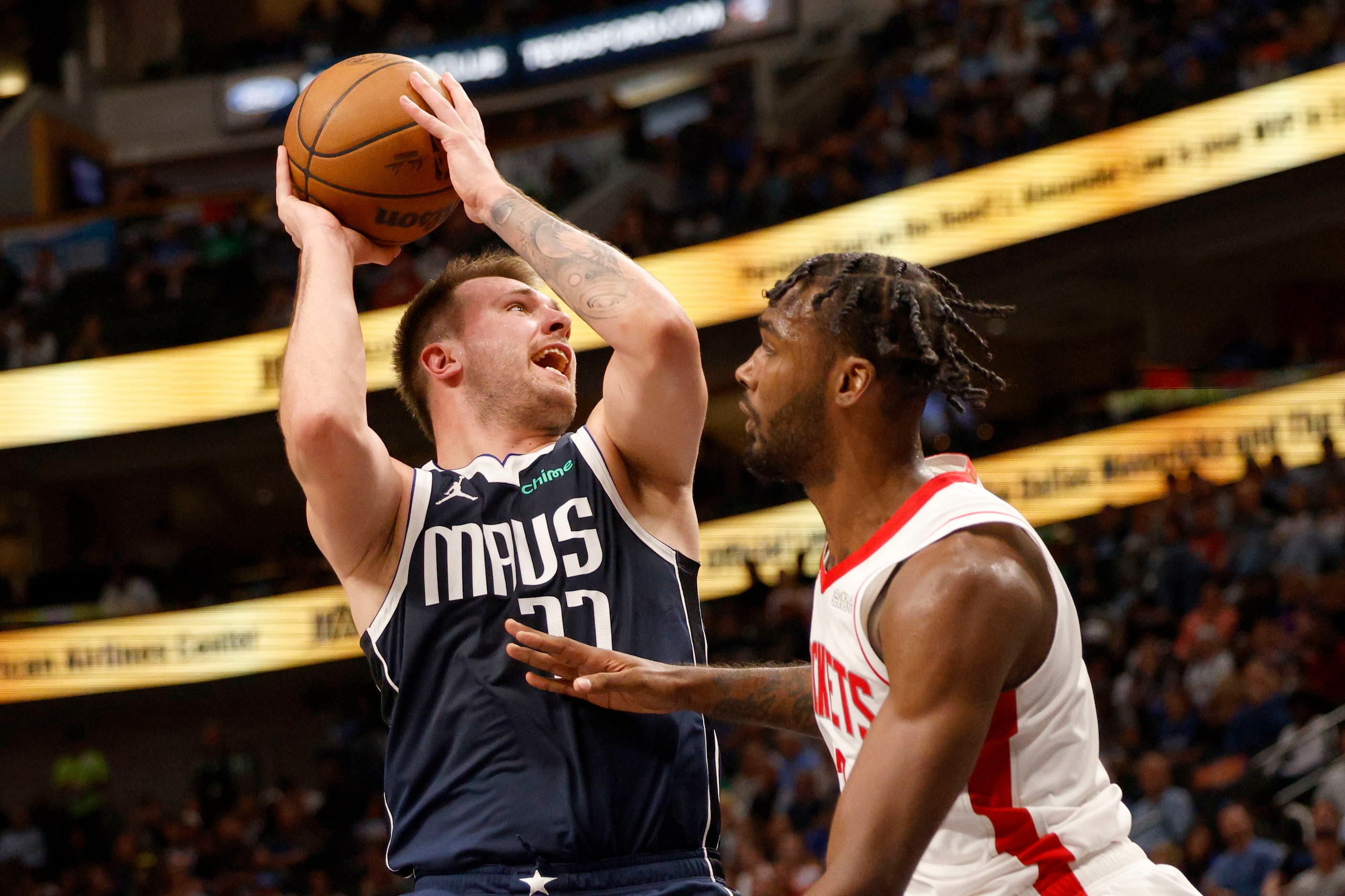 Dallas Mavericks guard Luka Doncic (77) shoots over Houston Rockets forward Tari Eason (17)...