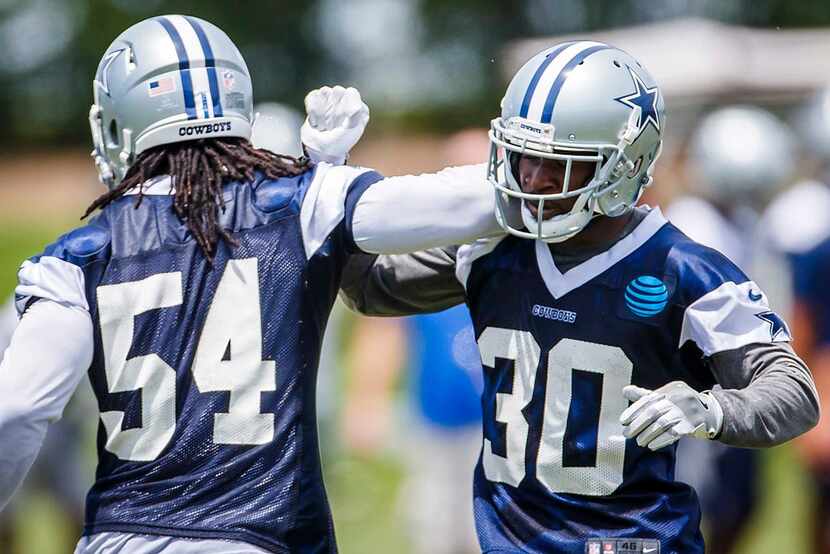 Dallas Cowboys linebacker Jaylon Smith (54) celebrates with cornerback Anthony Brown (30)...