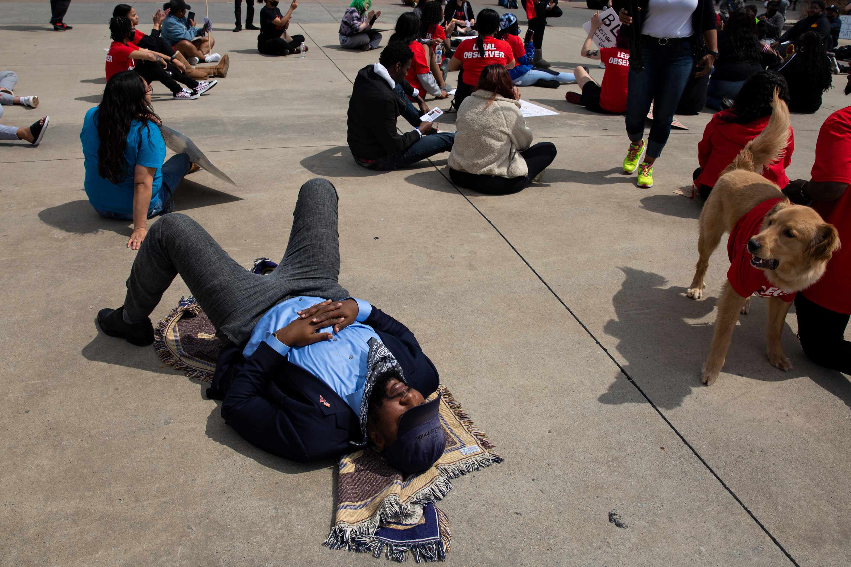 Attorney Lee Merritt lays down as demonstrators occupy an intersection in the Allen Outlets...
