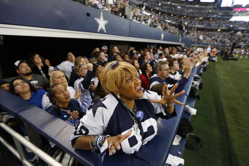 Dallas Cowboys fan Carolyn Price, of Lancaster, Texas, yells in between plays during a...