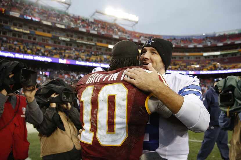 Redskins quarterback Robert Griffin III (10) and Cowboys quarterback Tony Romo (9) meet on...