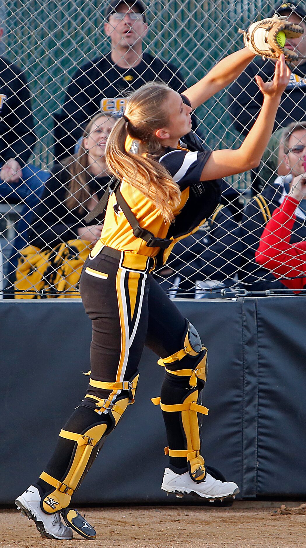 Plano East High School catcher Ashley Maeder (4) catches a foul ball for an out in the first...