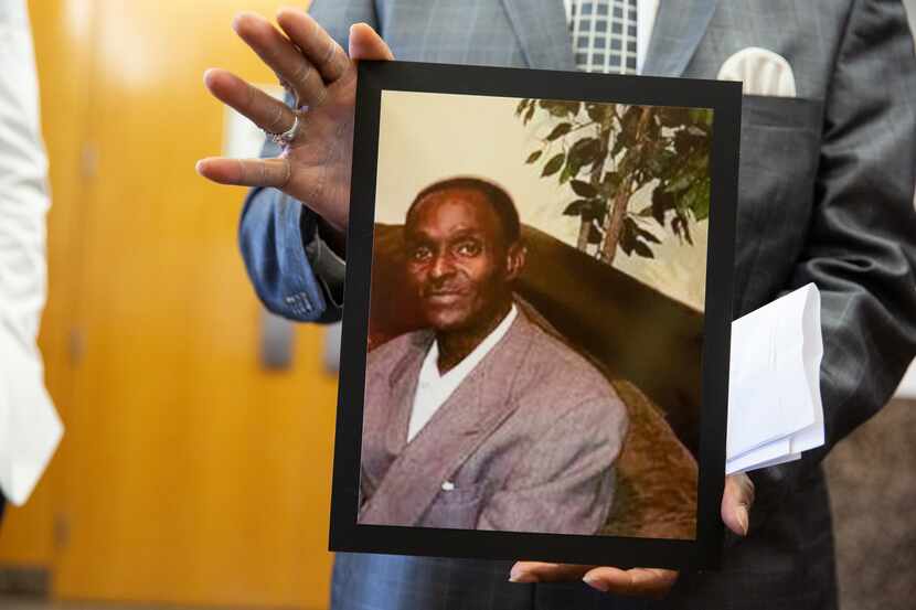 Kenneth R. Harris Sr. holds a photo of his 59-year-old brother Gerald Wayne Harris, who was...