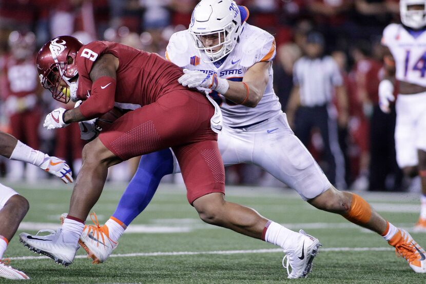 Boise State linebacker Leighton Vander Esch, right, brings down Washington State wide...