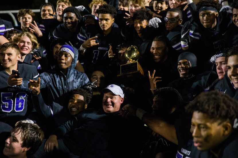 Frisco Independence football players pose for a photo with the bi-district championship...