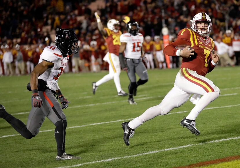 Iowa State quarterback Joel Lanning, right, scores on a 35-yard touchdown run ahead of Texas...