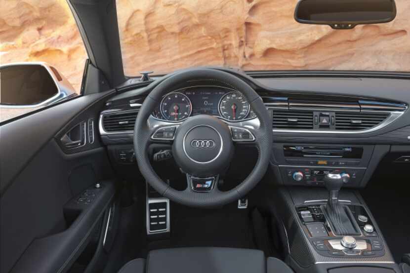 After the RS 7 starts, an iPad-size screen flips out from the middle of the dashboard that...