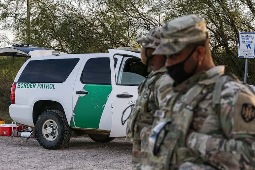 Army guardsmen that provide support to the border patrol, stand vigilant near the Texas...