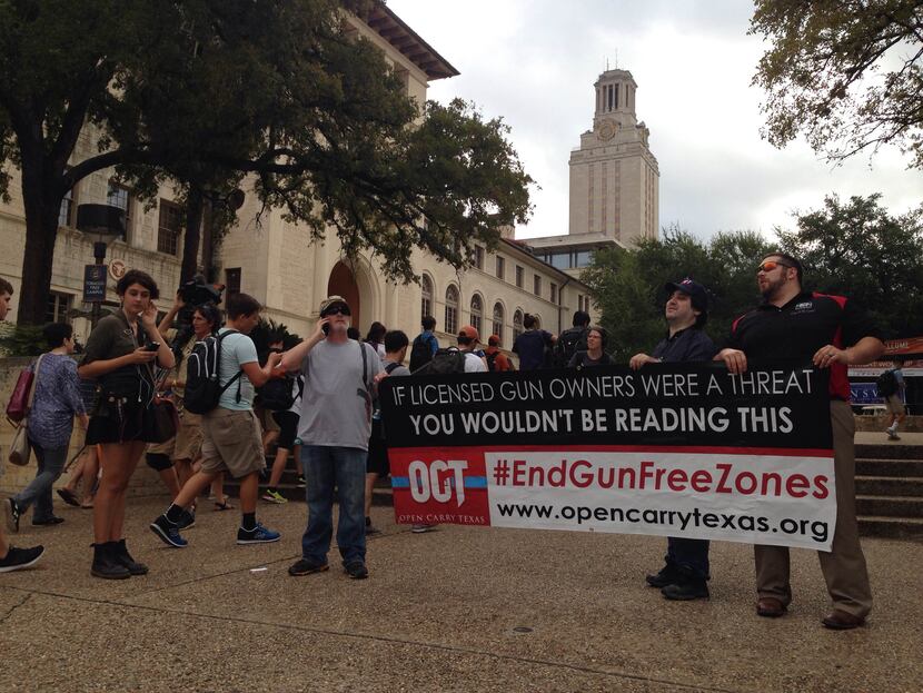 Gun-rights advocates from Open Carry Texas, including leader C.J. Grisham (left), were in...