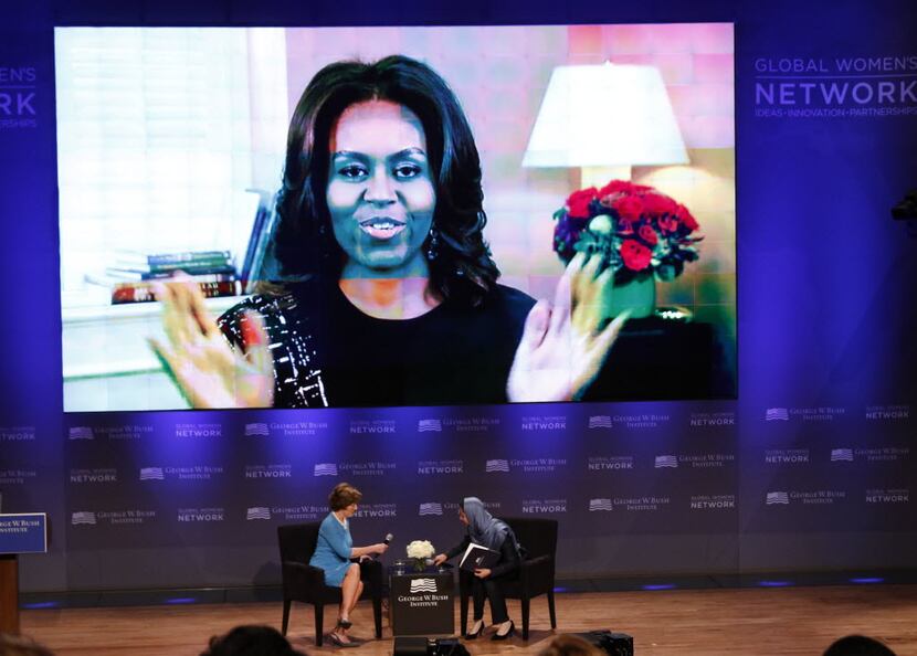 Former First Lady Laura Bush, left, joined First Lady Michelle Obama via teleconference as...