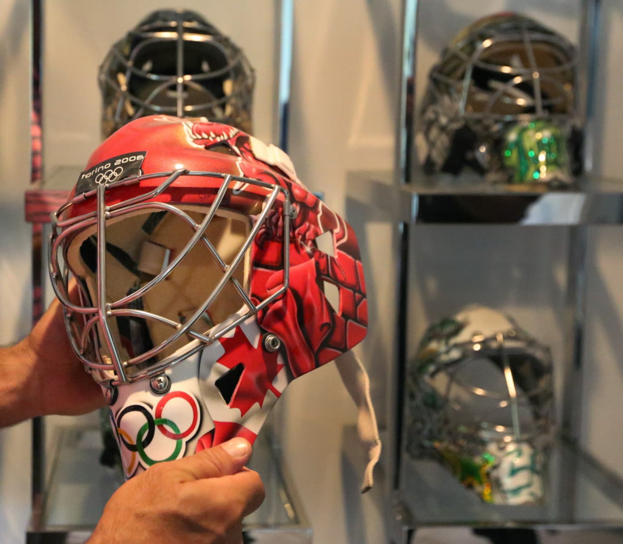 Former Dallas Stars goalie Marty Turco shows the mask he wore in the 2006 Olympics, at his...