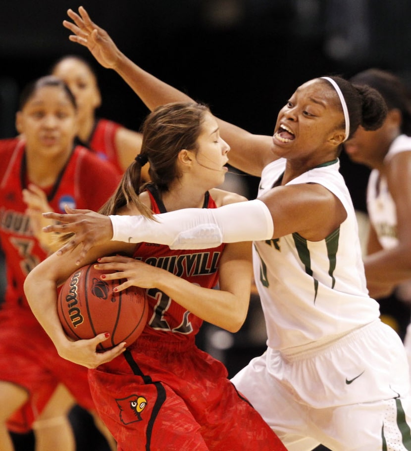 Baylor Bears guard Odyssey Sims (0) defends Louisville Cardinals guard Jude Schimmel (22) as...