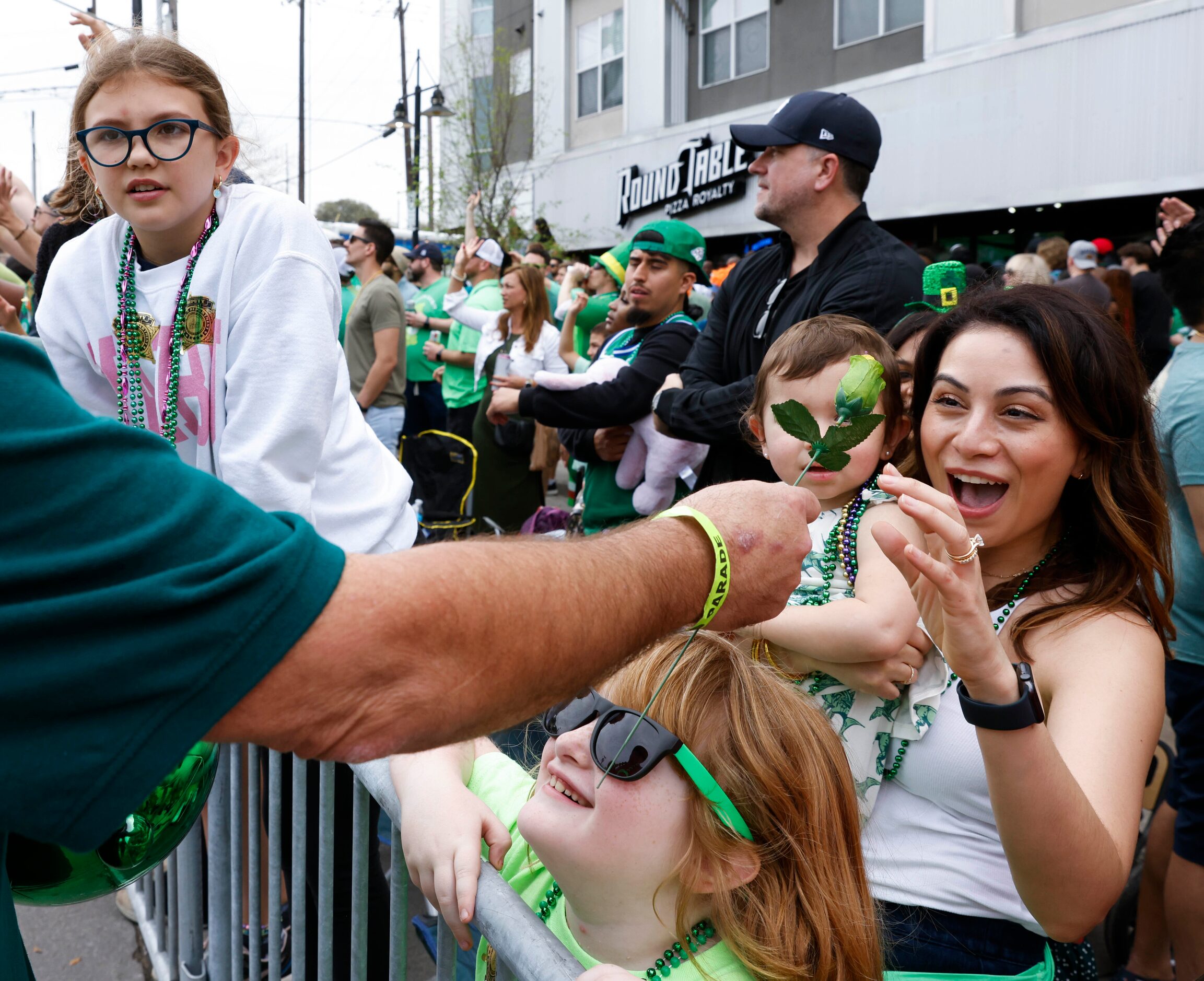 Bianca Caram carrying her daughter Jules Willey, 1, reacts as she receives a lucky green...