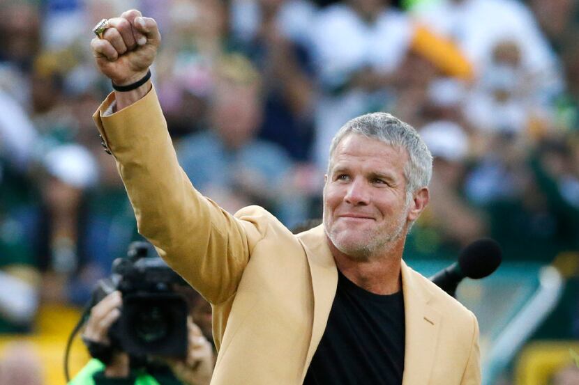 Former Green Bay quarterback Brett Favre celebrates having his name unveiled in the stadium...