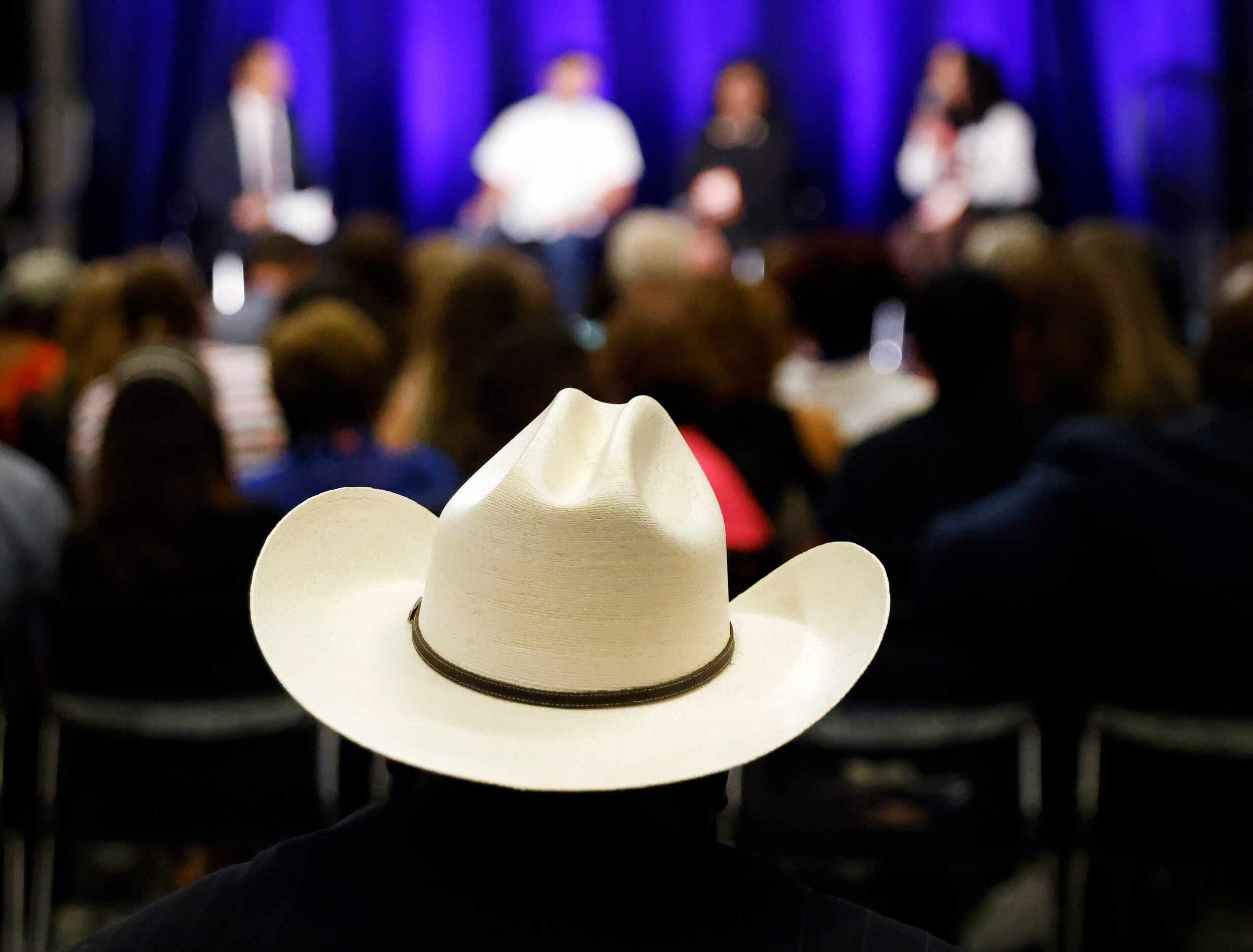 Delegates and guests listen to U.S. House Texas District candidates at a kick-off reception...