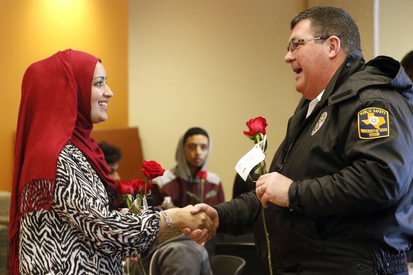 Hafsah Adil, left, gave a rose to David Spigelmyer at University of Texas at Dallas on...