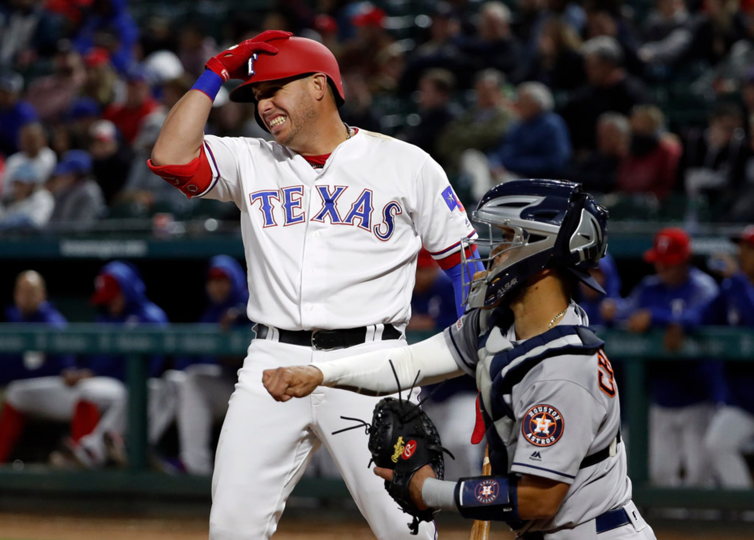 Texas Rangers' Asdrubal Cabrera holds his helmet after a strike call in the eighth inning of...