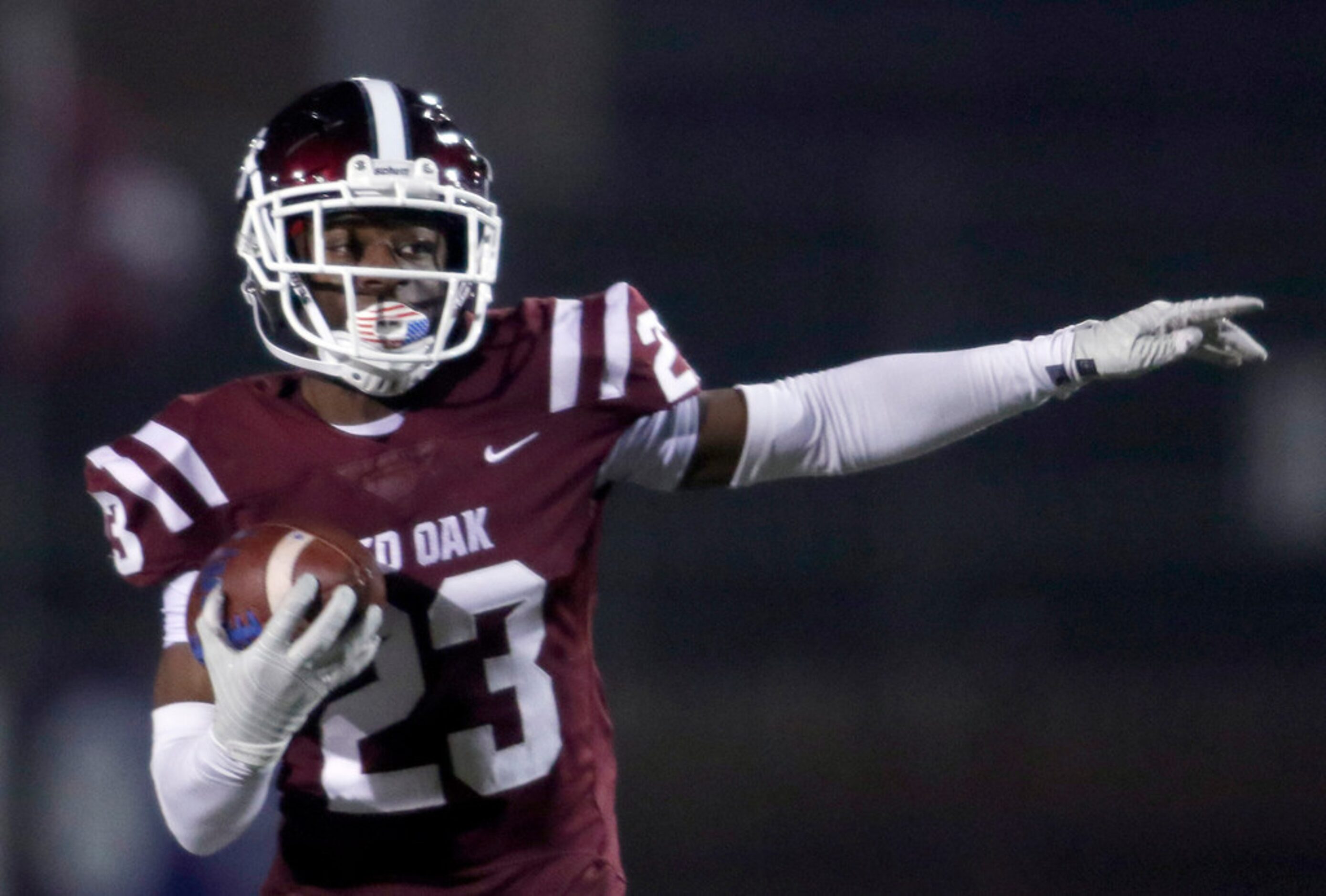 Red Oak defensive back Amarion Craddock (23) looks for a running lane after intercepting a...