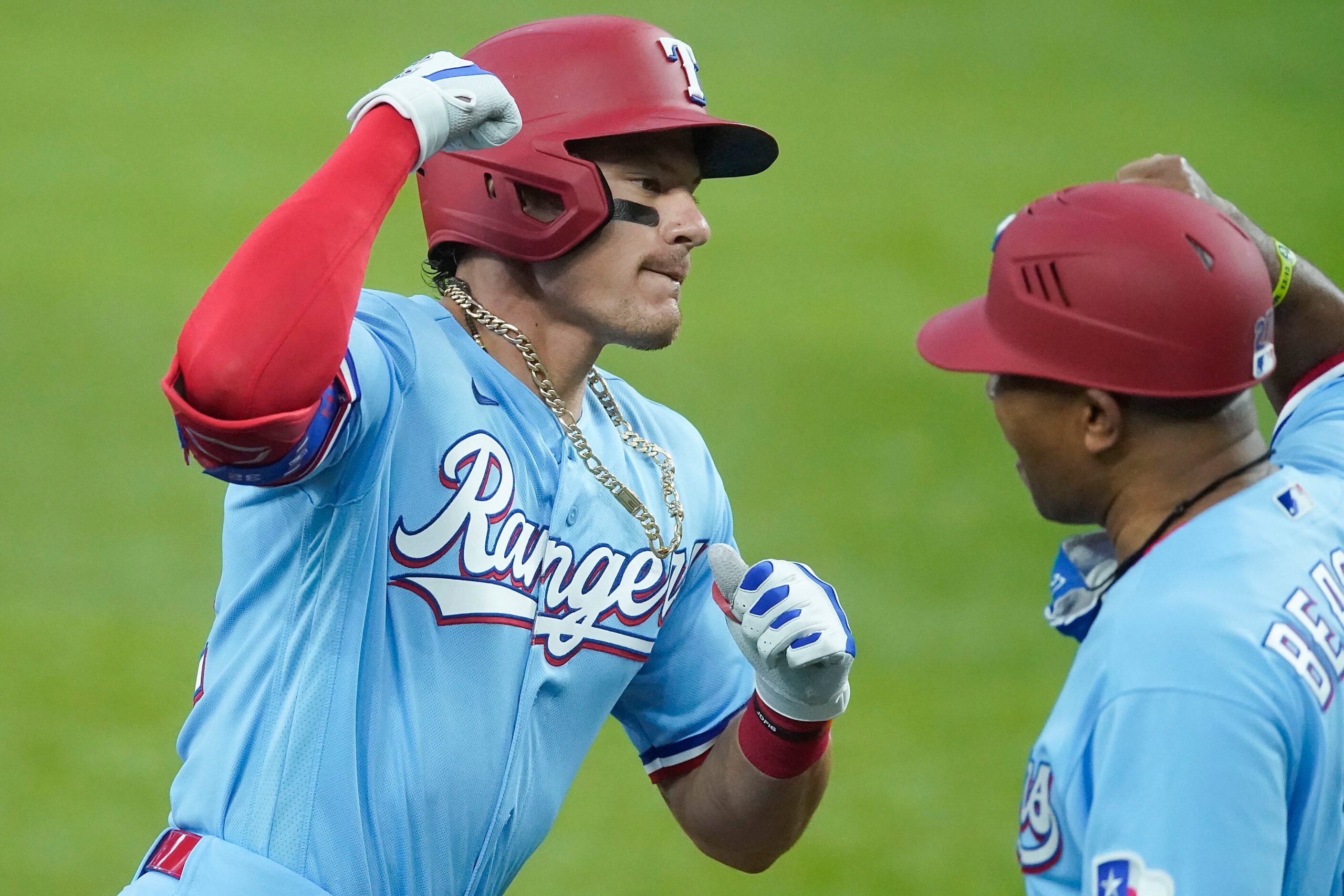 Texas Rangers designated hitter Derek Dietrich celebrates with third base coach Tony Beasley...