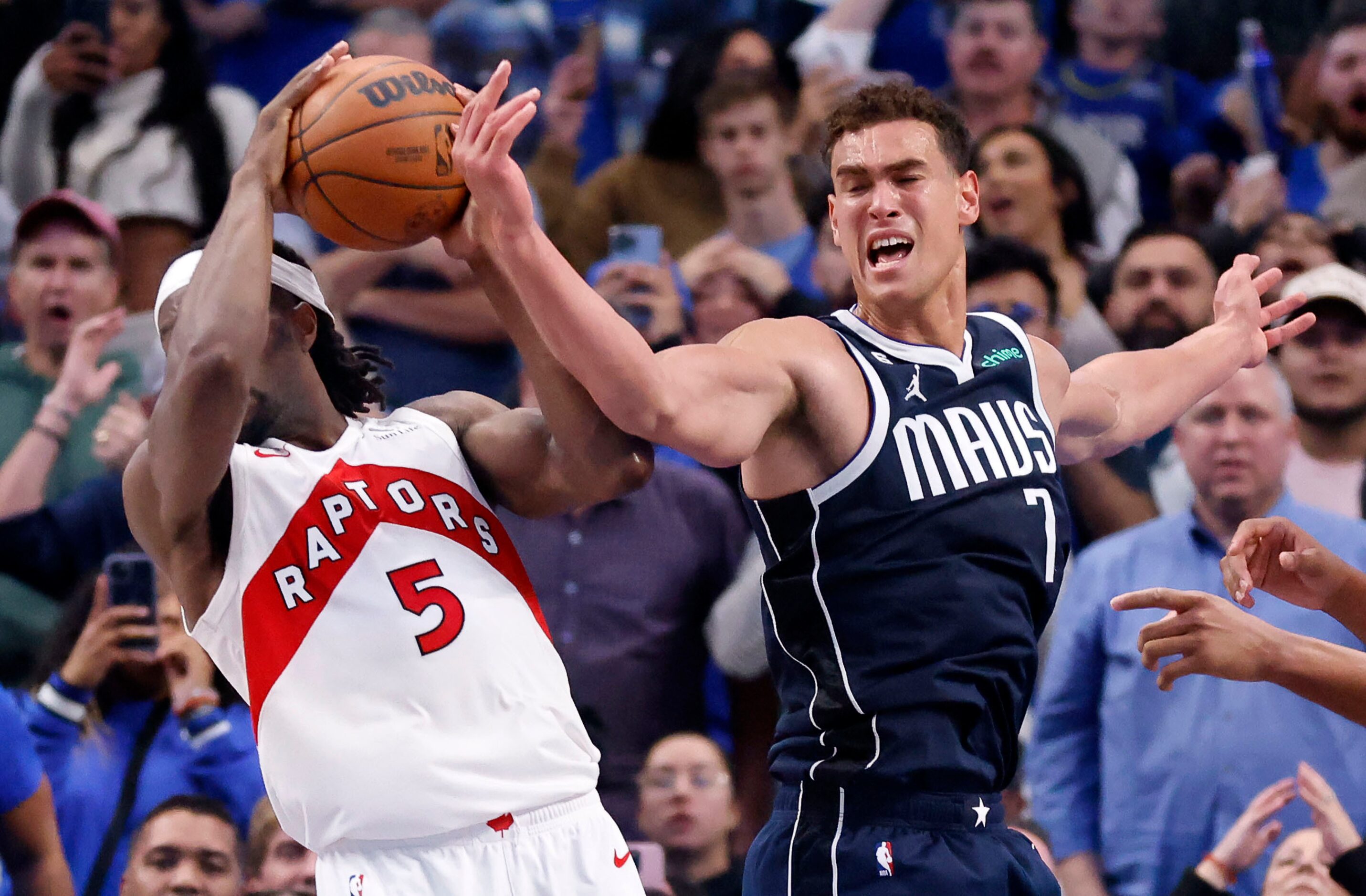 Dallas Mavericks center Dwight Powell (7) looks to reclaim the ball from Toronto Raptors...