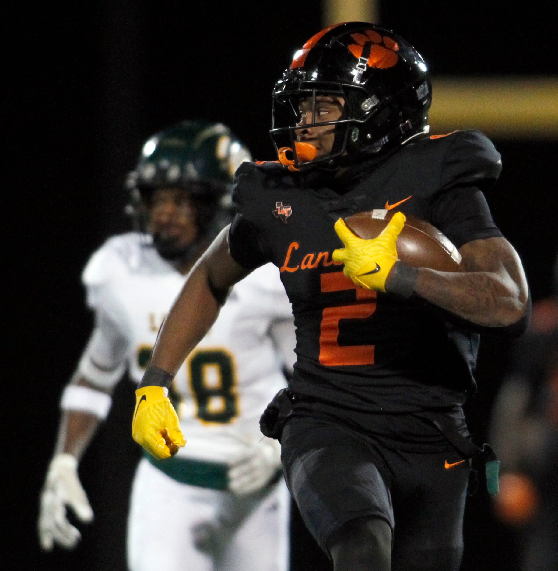 Lancaster running back Kewan Lacy (2) looks over his shoulder enroute to an 87-yard rushing...