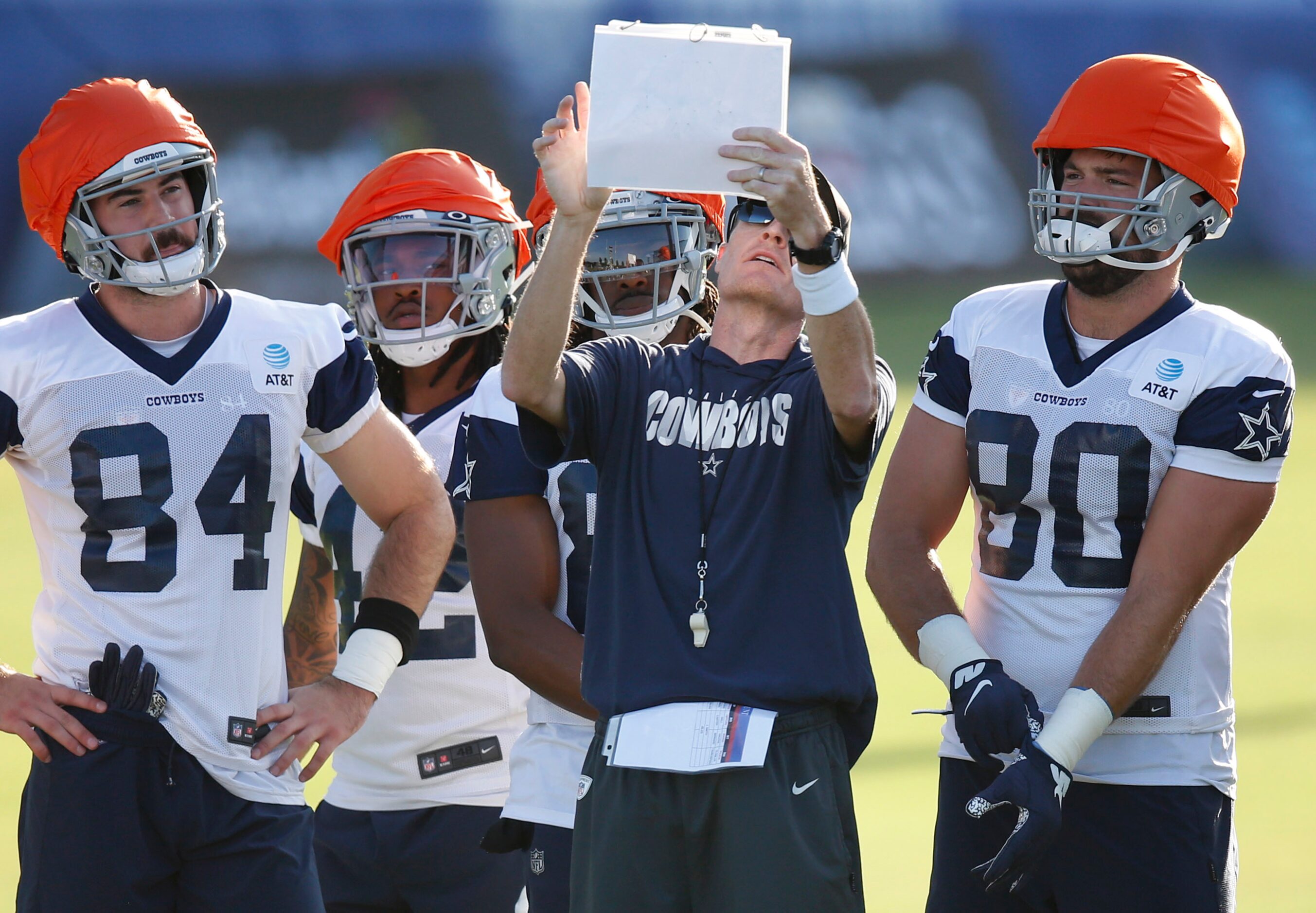 Dallas Cowboys special teams coach John Fassel goes over the next play with players during...