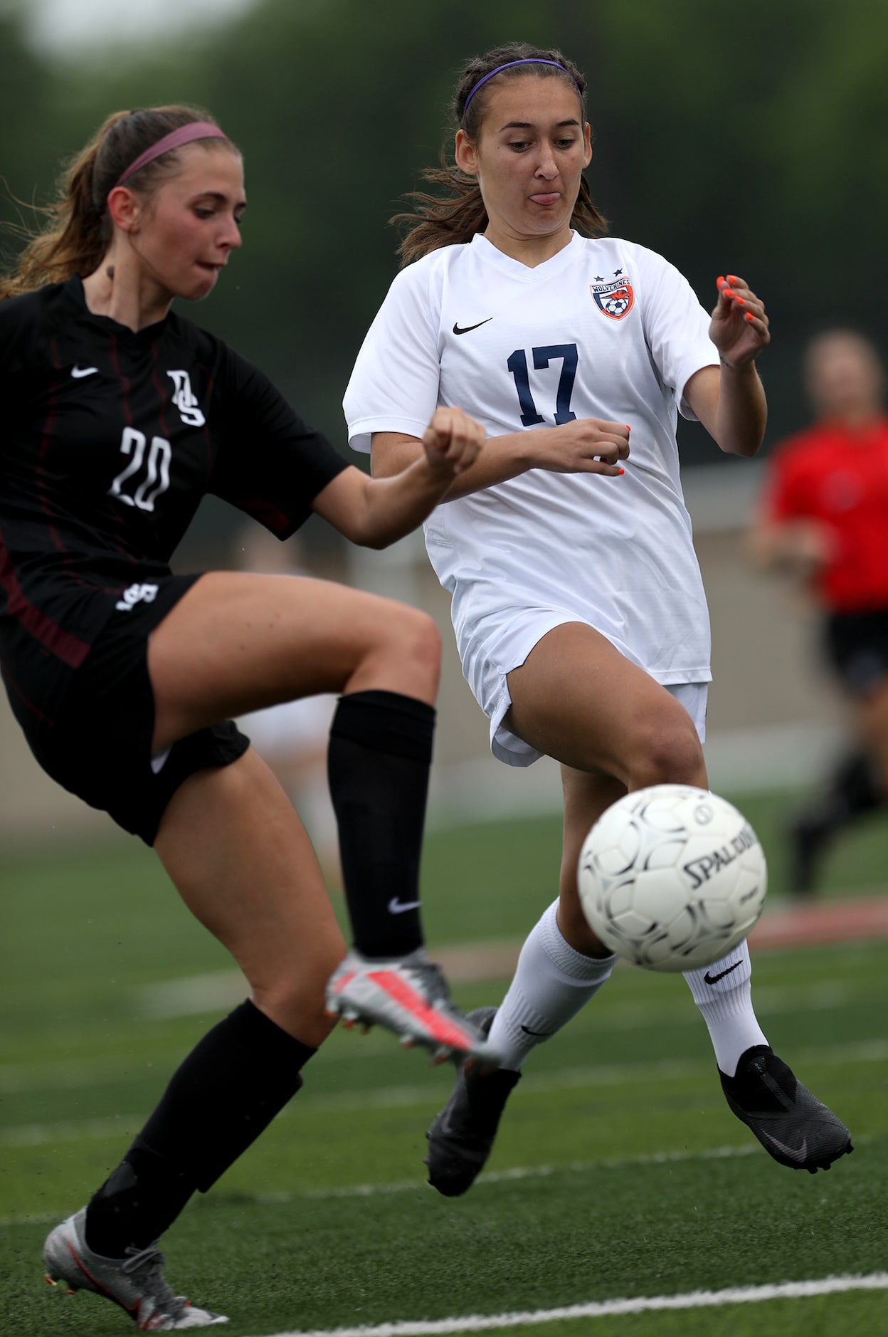 Wakeland's Lilian Wallace (17) and Dripping Springs' Kaleigh Howell (20) go after the ball...