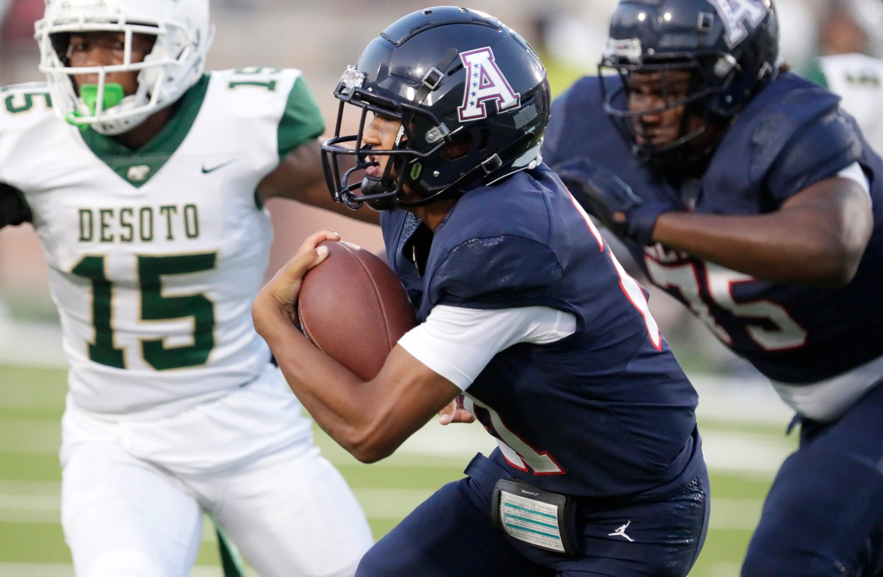 Allen High School running back Brett Holloway (21) carries the ball during the first half as...