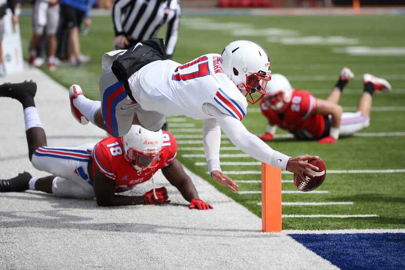 Southern Methodist Mustangs quarterback Austin Upshaw (17) is pushed out of bounds by...