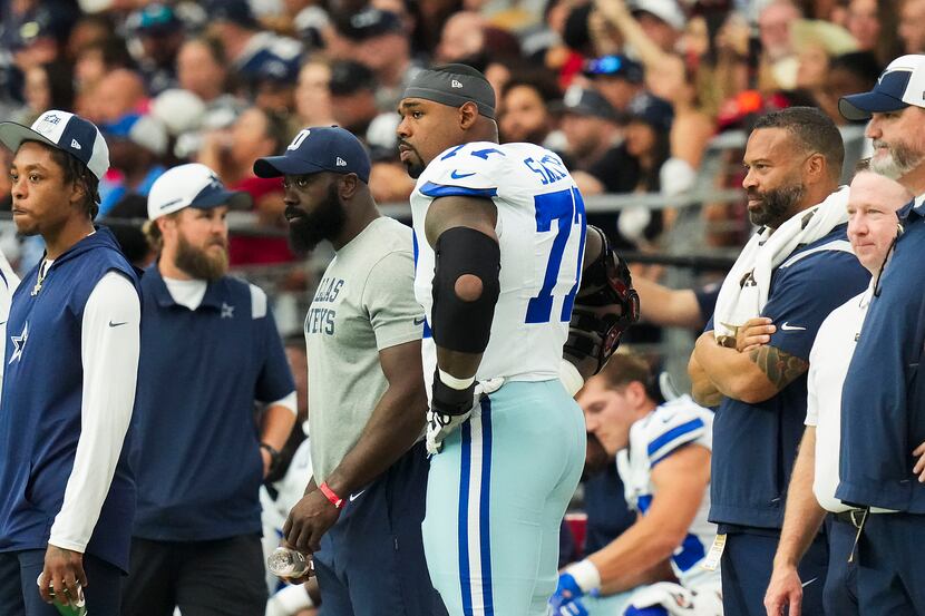 Dallas Cowboys offensive tackle Tyron Smith (77) watches from the sidelines during the first...