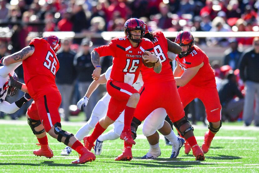 LUBBOCK, TX - NOVEMBER 18: Nic Shimonek #16 of the Texas Tech Red Raiders finds running room...