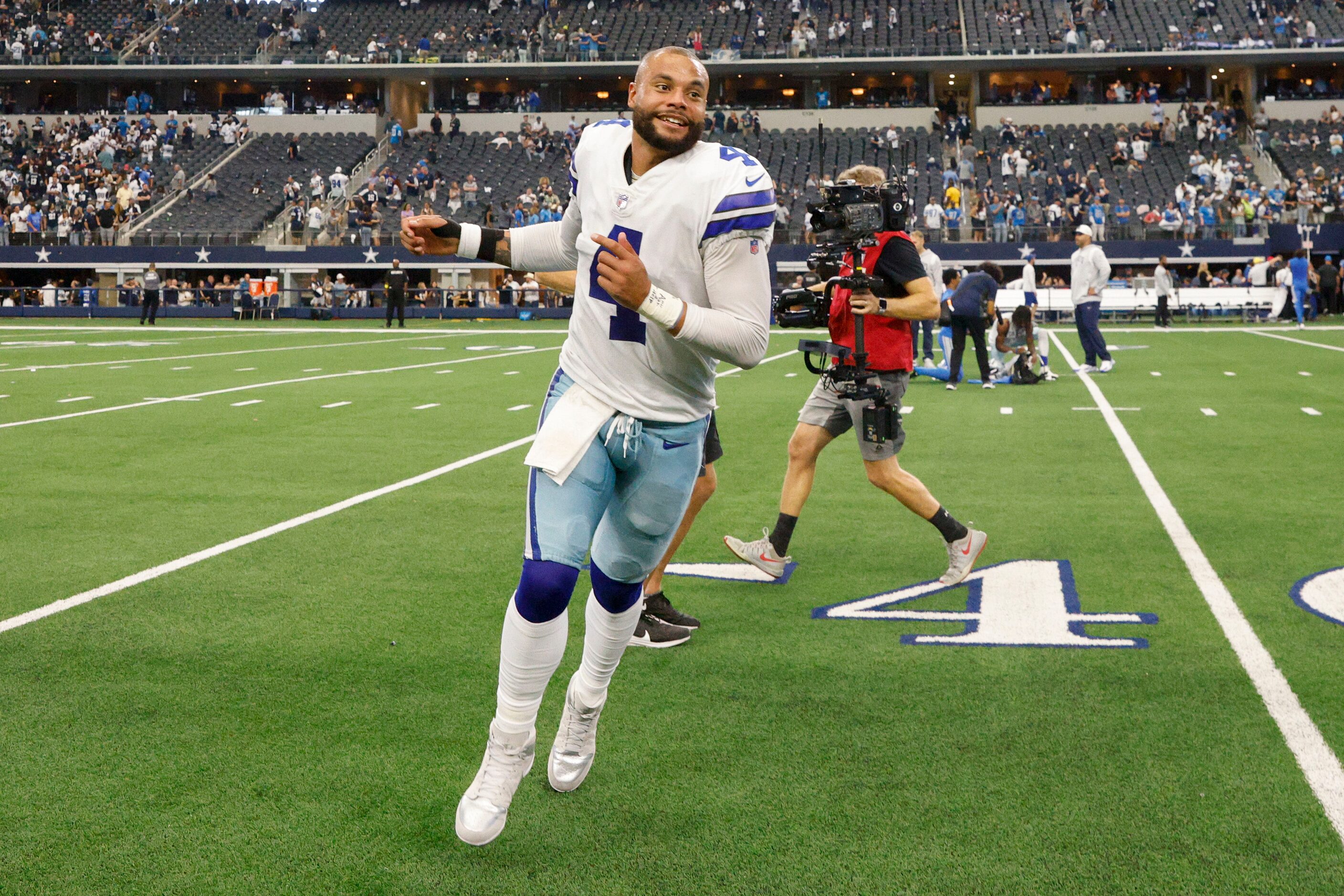 Dallas Cowboys quarterback Dak Prescott (4) runs off the field after winning a NFL game...