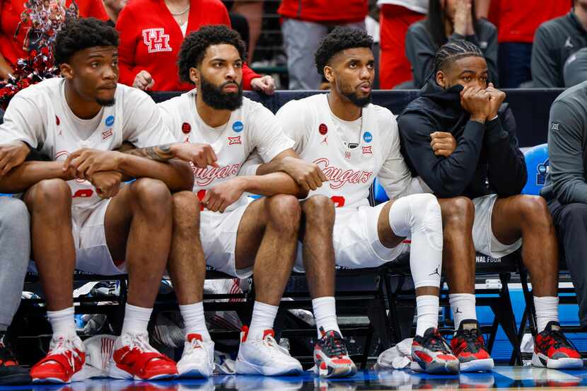 Houston guard Jamal Shead (right) holds arms with teammates during the final minutes of the...
