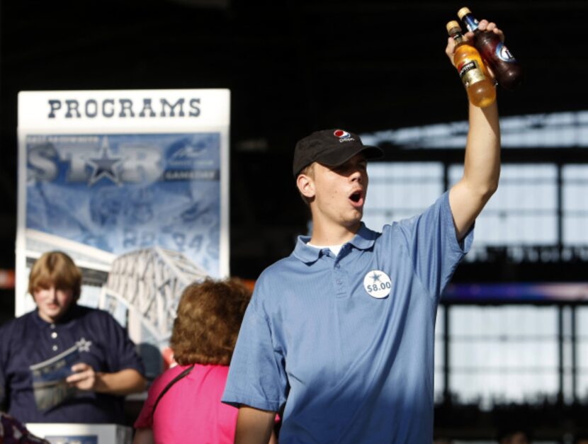 Beer vendor Baron Copeland sold his goods before the inaugural game at Cowboys Stadium on...