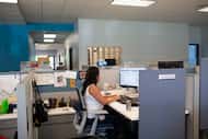 Social worker Lupita Armijo-Garcia works at her desk in the Ottawa County, Mich., Department...