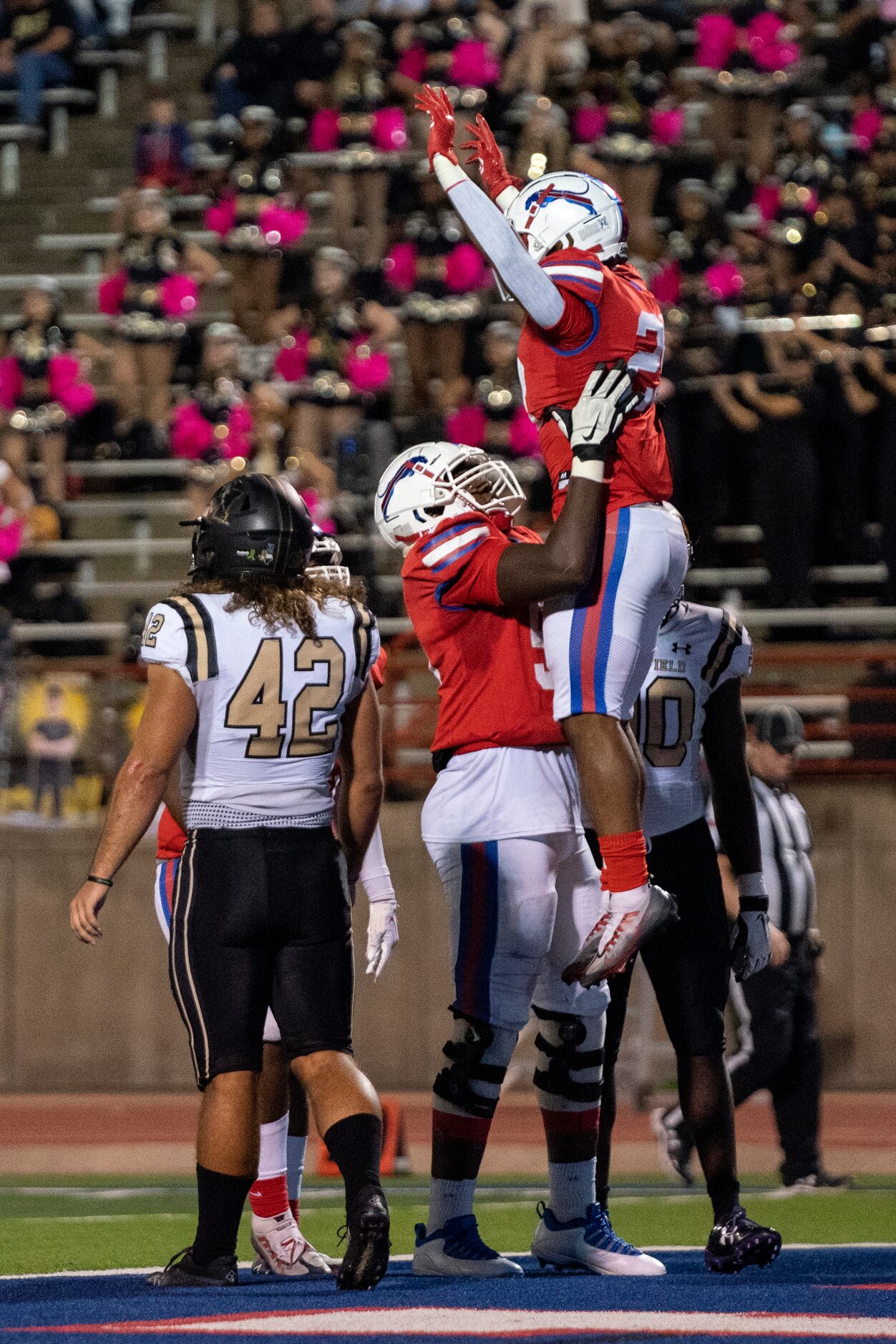 Duncanville junior running back Caden Durham (29) is lifted in the air by senior offensive...