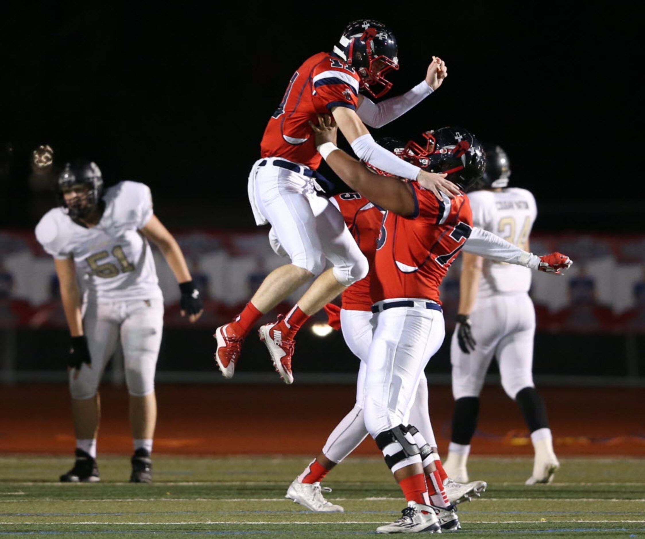 Frisco Centennial's Court Walker (11) celebrates a 78 yard touchdown run with teammate Zain...