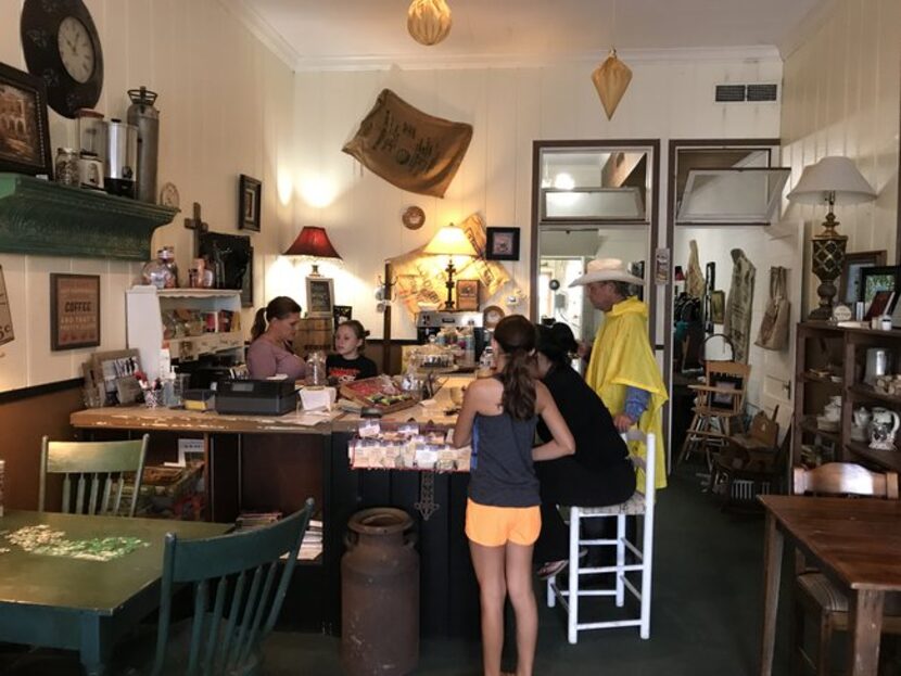 Schulenburg residents gather at the counter of The Shop Downtown, which reopened Monday...