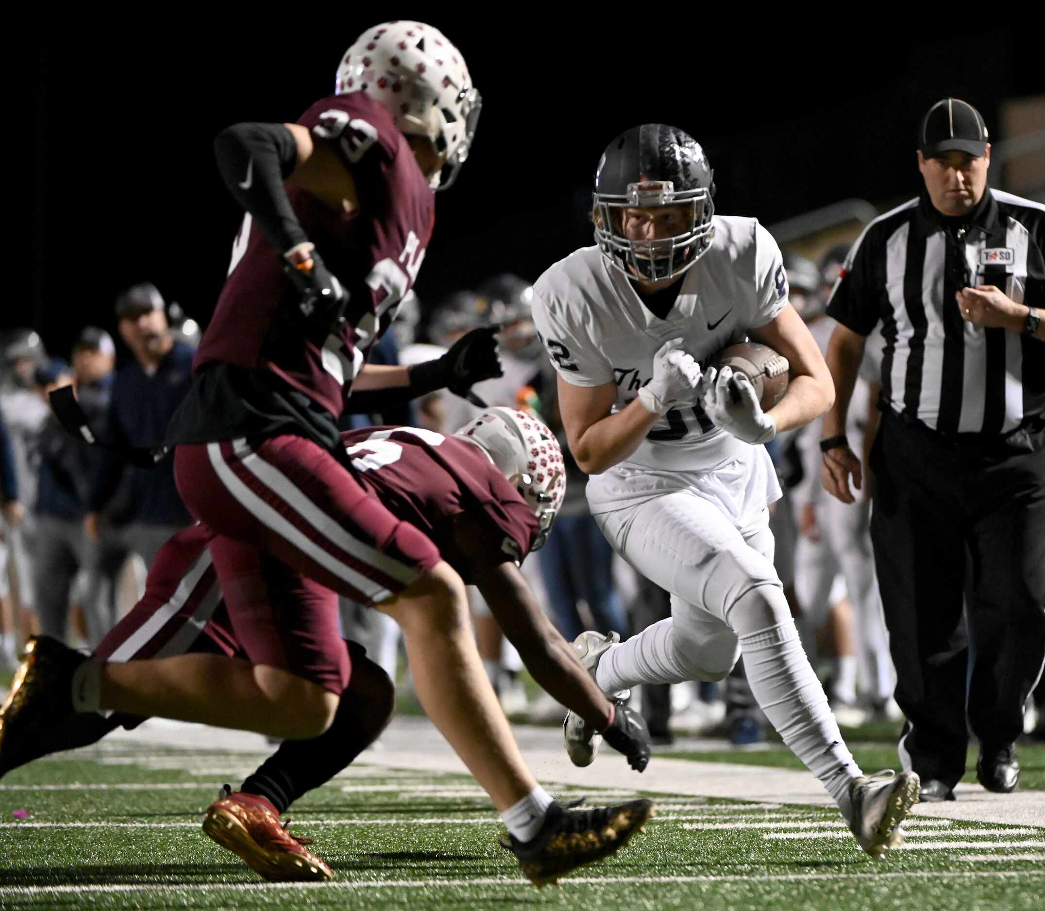 Flower Mound's Jason Welch (82) runs upfield as Plano's Kavion Grady (6) and  Kennon James...